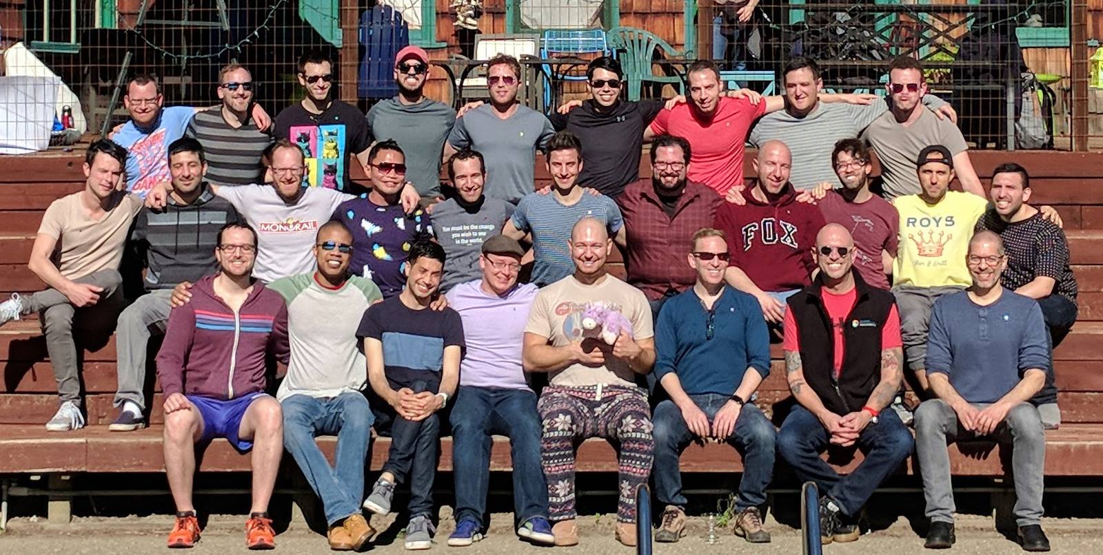 NJB+ members gathered together on the steps at a community retreat